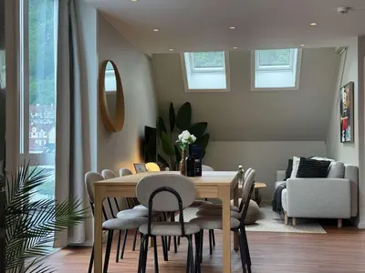a dining room with a table and chairs at Heimby Homes - Four Bedroom Family Penthouse in Bergen