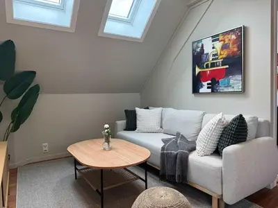a living room with a couch and a table at Heimby Homes - Four Bedroom Family Penthouse in Bergen