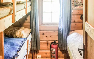 a bedroom with two bunk beds and a window at 4 Bedroom Stunning Home In Tynset in Tynset