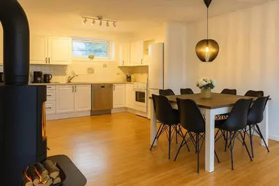 a kitchen and dining room with a table and chairs at Fjordpust og fjellsteg - Stryn in Stryn