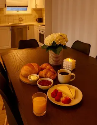 a table with bread and other foods on it at Fjordpust og fjellsteg - Stryn in Stryn