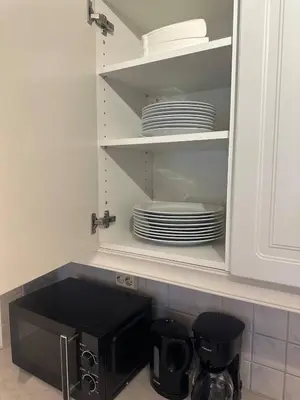 a microwave in a kitchen with plates in it at Fjordpust og fjellsteg - Stryn in Stryn