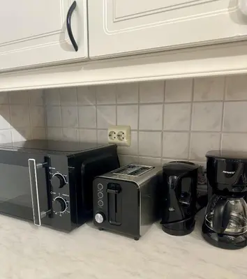 a kitchen counter with a coffee maker and a toaster at Fjordpust og fjellsteg - Stryn in Stryn