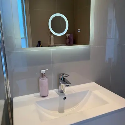 a bathroom sink with a soap dispenser next to a mirror at 047 Farmhouse - Nevlunghavn in Lii