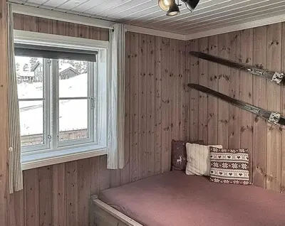 a room with a window and a bed in it at Modern Family Cabin By The Ski Lift in Flå