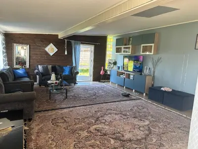 a living room with a couch and a tv at Scandinavian Style Ridabu Hamar in Hamar
