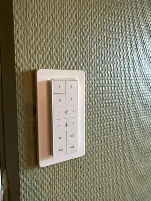 a white electrical outlet on a wall with a plug at Leilighet nært sentrum in Stryn