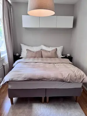 a bedroom with a large bed with a light at Stor 3-roms leilighet med utsikt in Trondheim