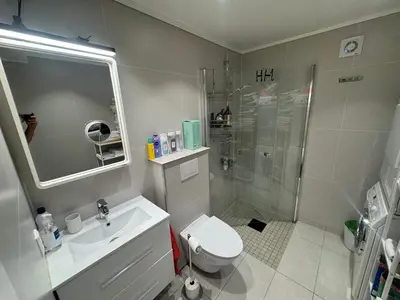 a bathroom with a shower and a toilet and a sink at Alesund center room with double bed in Ålesund