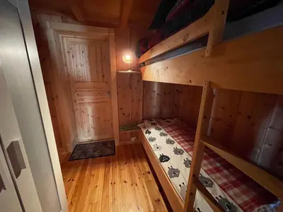 an attic room with bunk beds in a cabin at Thorpeset cabin by Norgesbooking - cabin with amazing view in Uvdal
