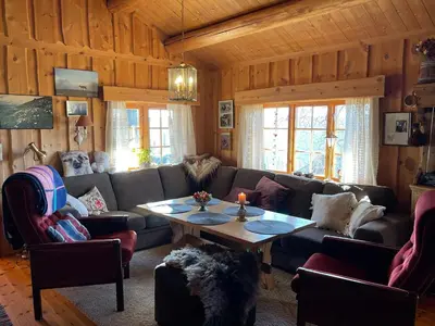 a living room with a couch and a table at Thorpeset cabin by Norgesbooking - cabin with amazing view in Uvdal
