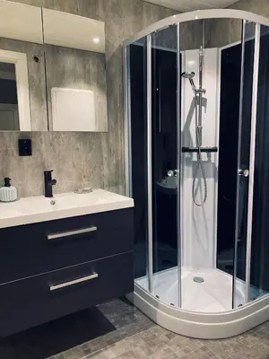 a bathroom with a shower and a sink at Petersstova in Ålesund