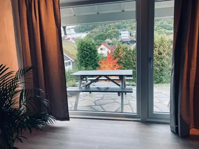 a picnic table in front of a sliding glass door at Petersstova in Ålesund