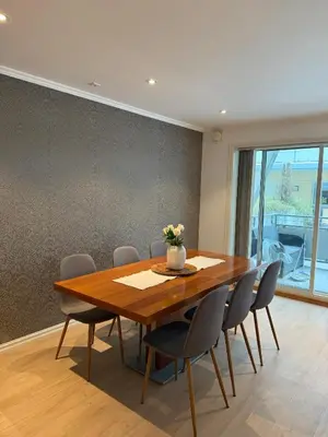 a dining room with a wooden table and chairs at Modern Apartment in City Center with Parking Garage in Ålesund