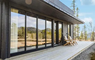 a house with glass windows and a wooden deck at 4 Bedroom Stunning Home In Eggedal in Eggedal