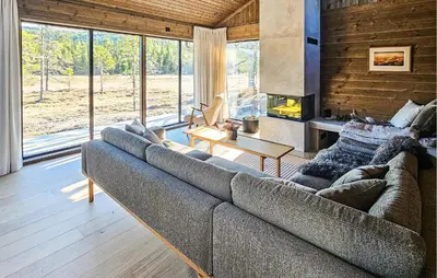 a living room with a couch and a fireplace at 4 Bedroom Stunning Home In Eggedal in Eggedal