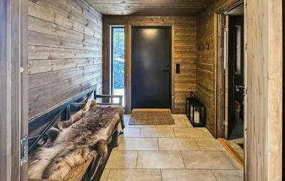 a hallway with a log wall and a door at 4 Bedroom Stunning Home In Eggedal in Eggedal