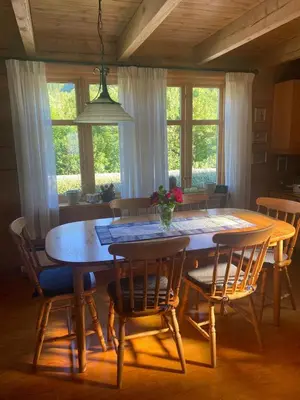 a dining room with a wooden table and chairs at Cozy house closw in Lii