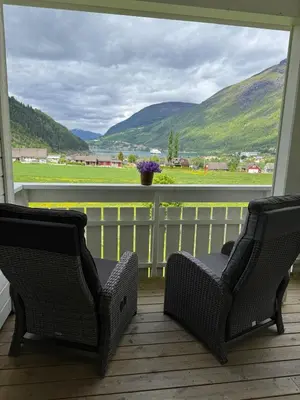 two chairs on a porch with a view of the mountains at Loen Panorama View in Loen