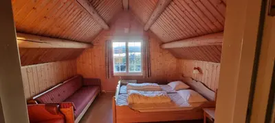 a small room with a bed and a window at Lauvåsen - Langleiken in Sør-Fron