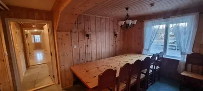 a dining room with a table and chairs and a window at Lauvåsen - Langleiken in Sør-Fron