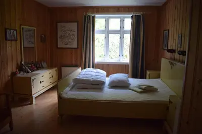 a bedroom with a bed with pillows and a window at Large house by nature reserve