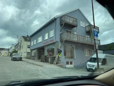 a man is standing outside of a building at Bakkebo in Åndalsnes
