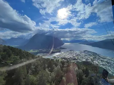 a view of a mountain and a lake with a rainbow at Bakkebo in Åndalsnes