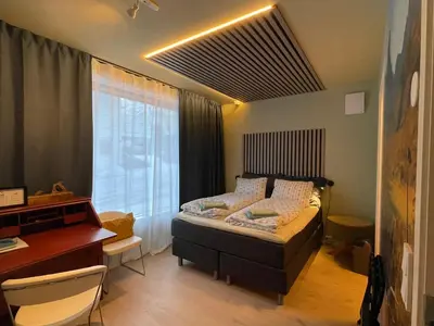a bedroom with a bed and a desk and a window at Bakkebo in Åndalsnes