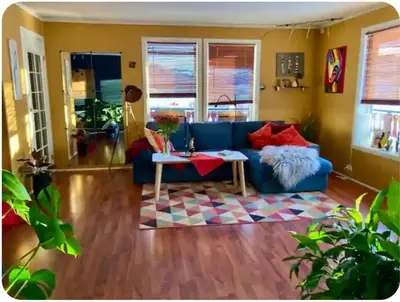 a living room with a blue couch and a table at Lilletun in Selbu