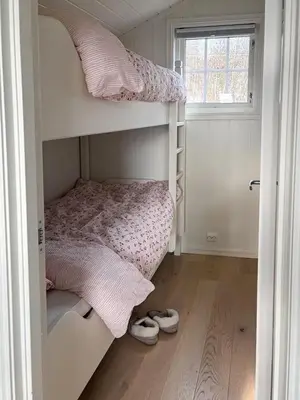 a bedroom with two bunk beds and a window at Modernized Log Cabin With Views Of The Mountains in Ron