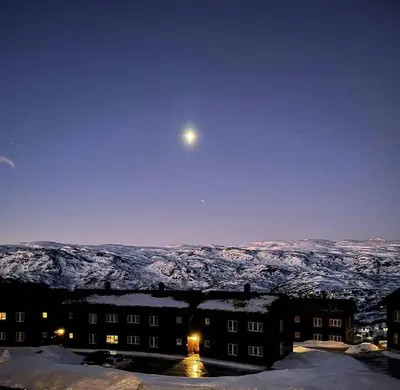 a view of the moon over a snow covered mountain at Family-Friendly Mountain Cabin In Haukeli in Nesland