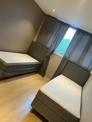 a small room with two beds and a window at Trondheim in Trondheim