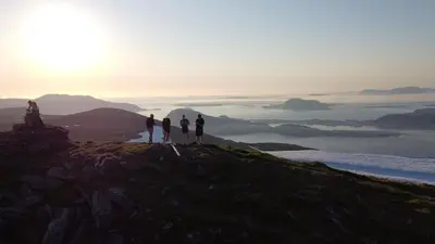 a group of people standing on top of a mountain at Attractive and central apartment in Ålesund