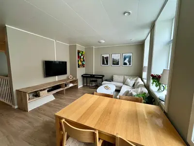 a living room with a table and a couch at Central apartment in Bergen City Center in Bergen