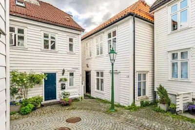 a row of white houses with a street light at Central apartment in Bergen City Center in Bergen
