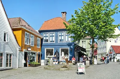 a blue building on a street in a town at Central apartment in Bergen City Center in Bergen