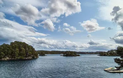 a large lake with two islands in the water at Cozy Home In Lepsøy With House Sea View in Lepsøy