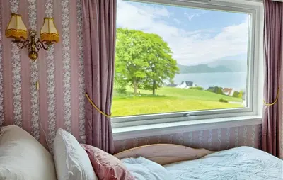a bedroom with a window with a view of the water at Awesome Home In Fitjar With Wifi in Fitjar