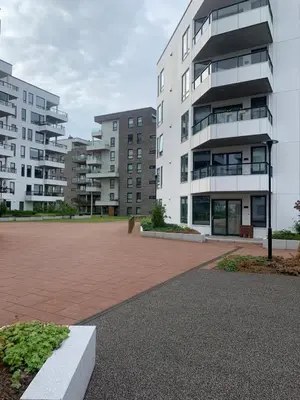 a parking lot in front of a large building at Lys og moderne 3-roms på Sandsli in Bergen