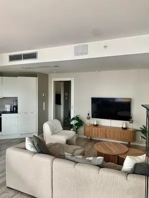 a living room with a couch and a flat screen tv at Lys og moderne 3-roms på Sandsli in Bergen