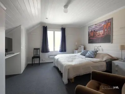 a bedroom with a bed and a window and a couch at Hus nær butikk, sentrum & rekreasjon in Hol