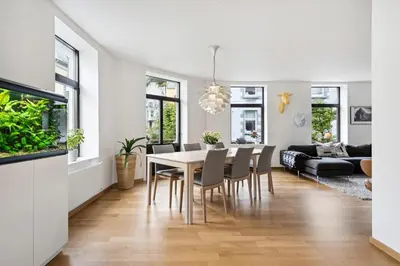 a dining room and living room with a table and chairs at A Gem in the Heart of Ålesund in Ålesund