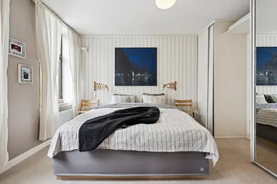 a bedroom with a bed and a large window at A Gem in the Heart of Ålesund in Ålesund