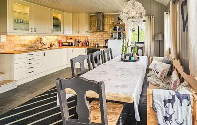 a kitchen with a table and chairs in a room at Stunning Home In Edland With Sauna in Nesland