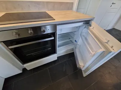 a kitchen with an open refrigerator with a stove at Cozy flat with lake view and 15 min from Bergen in Bergen