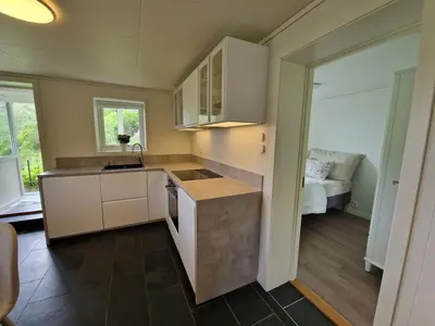 a kitchen with a sink and a counter top at Cozy flat with lake view and 15 min from Bergen in Bergen