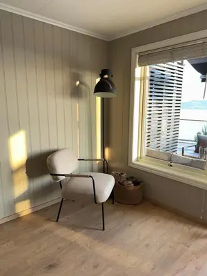 a room with a table and a chair and a window at 2 leiligheter med panoramautsikt in Bergen