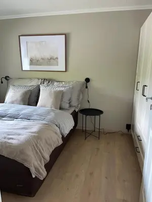 a bedroom with a bed and a table at 2 leiligheter med panoramautsikt in Bergen