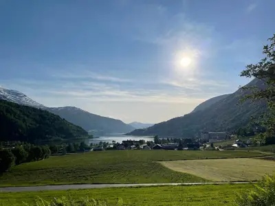a view of a valley with a lake and mountains at Arnestova - villagehouse in Loen in Loen